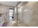 A modern bathroom features a glass walk-in shower and double vanity at 10332 Stroma Ave, Las Vegas, NV 89166