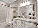 Bright bathroom with a double vanity, framed mirrors, and a shower/tub combo, creating a serene atmosphere at 10332 Stroma Ave, Las Vegas, NV 89166