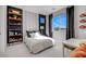 Stylish bedroom featuring a modern bed, playful wall decor, and a bright window for a cheerful space at 10332 Stroma Ave, Las Vegas, NV 89166