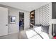 Modern bedroom featuring a unique football-themed accent wall, floating shelves, and an open closet at 10332 Stroma Ave, Las Vegas, NV 89166