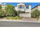 Charming two-story home with a two car garage, well-maintained landscaping, and a brick paver driveway at 10332 Stroma Ave, Las Vegas, NV 89166