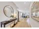 Bright foyer featuring wood floors and decor provides access to other spaces in the home at 10332 Stroma Ave, Las Vegas, NV 89166