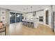 Bright kitchen featuring a large island, bar seating, modern appliances, and sliding glass doors to the patio at 10332 Stroma Ave, Las Vegas, NV 89166