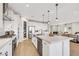 Open-concept kitchen featuring a large island with seating, stainless steel appliances, and plenty of counter space at 10332 Stroma Ave, Las Vegas, NV 89166