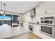 Modern kitchen features sleek countertops, stainless steel appliances, and a large window view at 10332 Stroma Ave, Las Vegas, NV 89166
