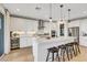 Bright kitchen features bar seating, stainless steel appliances, recessed lighting, and ample storage at 10332 Stroma Ave, Las Vegas, NV 89166