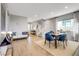 Open-concept living and dining area with stylish decor, comfortable seating, and a staircase leading to the upper level at 10332 Stroma Ave, Las Vegas, NV 89166