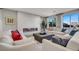 Comfortable living room showcasing a modern fireplace, plush seating, and natural light from the large windows at 10332 Stroma Ave, Las Vegas, NV 89166
