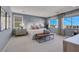 A well-lit primary bedroom with large windows and a stylish bench at 10332 Stroma Ave, Las Vegas, NV 89166