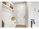 Cozy mud room with white cabinets and shelves, and seating area with a soft cushion at 10332 Stroma Ave, Las Vegas, NV 89166