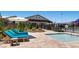 Community pool area features a jacuzzi, lounge chairs, patio furniture and umbrellas at 10332 Stroma Ave, Las Vegas, NV 89166