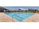 Inviting community pool with lounge chairs, umbrellas, and meticulously maintained surrounding landscaping at 10332 Stroma Ave, Las Vegas, NV 89166