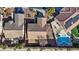 Aerial view of backyard with pool, patio, and meticulous landscaping with mature trees and shrubs at 1047 Amber Gate St, Henderson, NV 89002