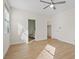A spacious bedroom featuring wood-look floors, a ceiling fan, an ensuite and a walk in closet at 1047 Amber Gate St, Henderson, NV 89002