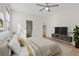 Comfortable bedroom features neutral tones, closet, modern TV and stand with easy access to the bathroom at 1047 Amber Gate St, Henderson, NV 89002