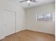 This bedroom features a ceiling fan, wood-look floors, closet and window with natural light at 1047 Amber Gate St, Henderson, NV 89002