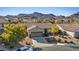 Single-Gathering home featuring a two-car garage, desert landscaping, and mountain views for a serene setting at 1047 Amber Gate St, Henderson, NV 89002