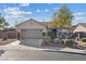 Charming single-story home featuring a two-car garage, landscaped front yard, and well-maintained lawn at 1047 Amber Gate St, Henderson, NV 89002