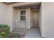 Inviting front entry with covered porch, modern door, and pleasant landscaping at 1047 Amber Gate St, Henderson, NV 89002