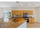 Well-lit kitchen with granite countertops, stainless steel appliances, and wood cabinets at 1047 Amber Gate St, Henderson, NV 89002