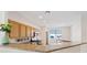 Bright kitchen area with wood cabinets, granite counters, stainless steel appliances, and an island at 1047 Amber Gate St, Henderson, NV 89002