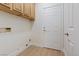 Functional laundry room with wood-look floors, storage space, and easy access at 1047 Amber Gate St, Henderson, NV 89002