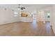 Open-concept living space with wood floors, seamlessly connecting living room and kitchen at 1047 Amber Gate St, Henderson, NV 89002