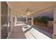Covered outdoor patio with ceiling fans, overlooking landscaped backyard for relaxation and entertainment at 1047 Amber Gate St, Henderson, NV 89002