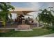 A playground with slides, climbing structures, and shade canopies on a grassy area at 1047 Amber Gate St, Henderson, NV 89002