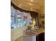 Stylish wet bar area with custom cabinetry and a view of the outdoor living space at 10657 San Vercelli Ct, Las Vegas, NV 89141