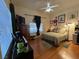 Cozy bedroom features natural light from a window, a bed, and a ceiling fan at 10657 San Vercelli Ct, Las Vegas, NV 89141