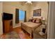 Charming bedroom featuring hardwood floors, a queen bed, and a window at 10657 San Vercelli Ct, Las Vegas, NV 89141