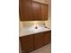 A light colored cabinet with a white countertop is illuminated by a table lamp at 10657 San Vercelli Ct, Las Vegas, NV 89141