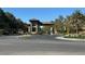 Community entrance with a decorative gatehouse and well-maintained landscaping at 10657 San Vercelli Ct, Las Vegas, NV 89141