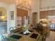 Kitchen featuring wooden cabinets, an island, and a dining table with decor at 10657 San Vercelli Ct, Las Vegas, NV 89141