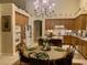 Inviting kitchen with a chandelier, wooden cabinets, and round dining table at 10657 San Vercelli Ct, Las Vegas, NV 89141
