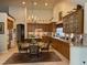Bright kitchen features a chandelier, wooden cabinets, and a dining table at 10657 San Vercelli Ct, Las Vegas, NV 89141