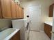 A laundry room featuring a white washer, dryer, storage cabinets, and white walls at 10657 San Vercelli Ct, Las Vegas, NV 89141