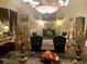 Elegant living room with beautiful chandeliers, artwork, and sophisticated decor at 10657 San Vercelli Ct, Las Vegas, NV 89141