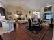 Spacious living room featuring elegant décor, a stylish dining area, and hardwood floors at 10657 San Vercelli Ct, Las Vegas, NV 89141