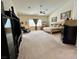 Spacious bedroom boasts a ceiling fan, seating area, and ample natural light from large windows at 10657 San Vercelli Ct, Las Vegas, NV 89141