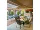 Outdoor patio with a dining table, umbrella, and a ping pong table for entertaining at 10657 San Vercelli Ct, Las Vegas, NV 89141