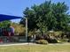 Shaded community playground with colorful play structures and a gazebo-covered seating area nearby at 10657 San Vercelli Ct, Las Vegas, NV 89141