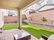 Inviting covered patio and artificial turf backyard space are perfect for outdoor living at 10806 Space Odyssey Ave, Las Vegas, NV 89129