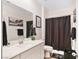 This well-lit bathroom features a modern vanity, decorative towels, and a framed art print at 10806 Space Odyssey Ave, Las Vegas, NV 89129