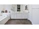Bright bathroom featuring a double vanity, soaking tub, and modern fixtures on wood-look flooring at 10806 Space Odyssey Ave, Las Vegas, NV 89129