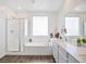 Bright and spacious bathroom with glass-enclosed shower, tub, double vanity and modern fixtures at 10806 Space Odyssey Ave, Las Vegas, NV 89129