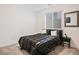 This cozy bedroom is illuminated by natural light with a large window and has black and white themed decor at 10806 Space Odyssey Ave, Las Vegas, NV 89129