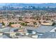 This is an aerial view of rooftops with a mountain range and the city skyline in the background at 10806 Space Odyssey Ave, Las Vegas, NV 89129