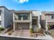 Charming two-story home features a balcony, well-manicured landscaping, and a brick driveway at 10806 Space Odyssey Ave, Las Vegas, NV 89129